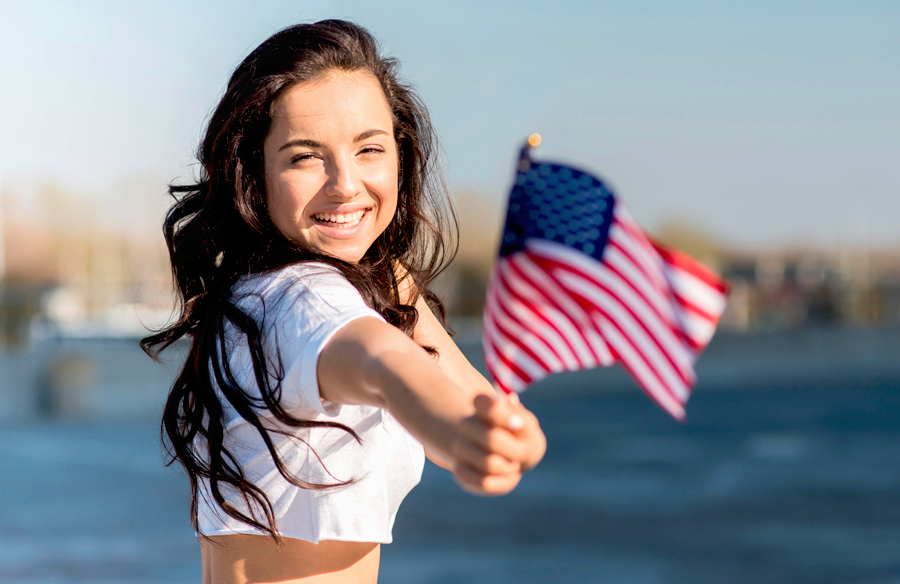 International student holding an American flag